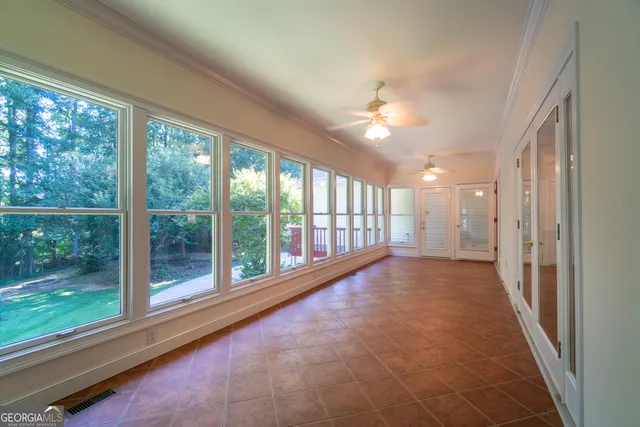 a spacious bathroom with a granite countertop sink a bathtub and next to a window