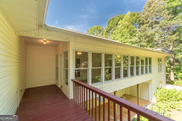 a spacious bathroom with a granite countertop sink a toilet a mirror a bathtub and shower