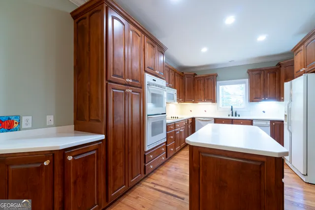 a view of an empty room with a chandelier fan