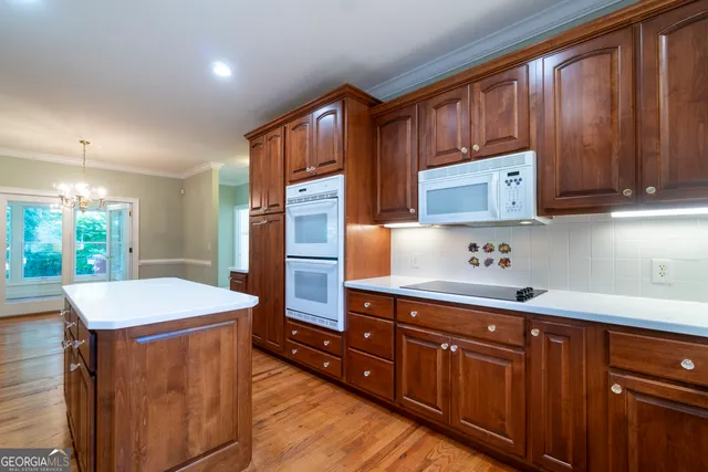 an empty room with a fan & a window