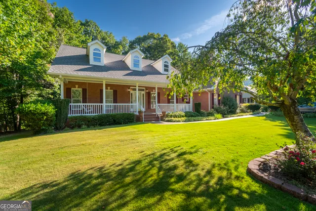 a view of a house with a yard and a garden