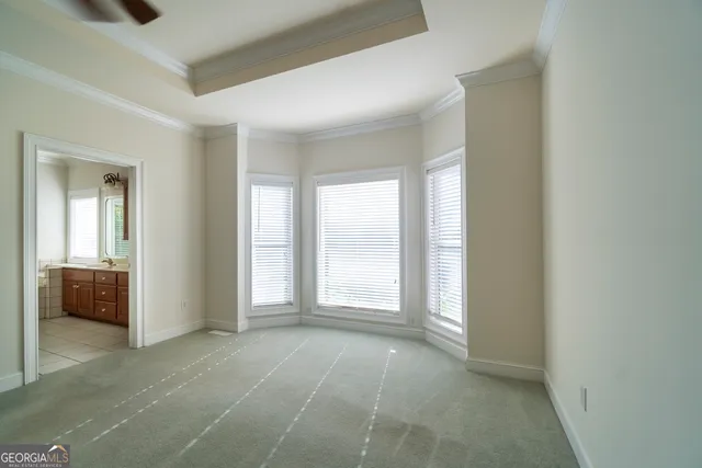 a view of a house with backyard and trees