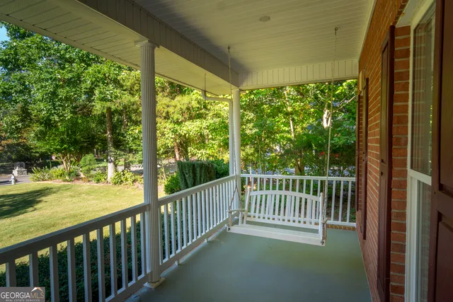 a view of a room with wooden floor and chandelier