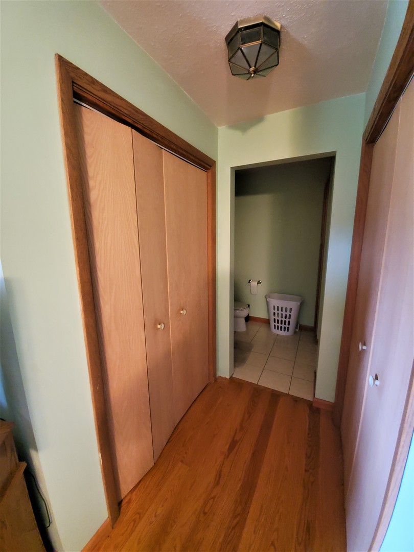8776 Wolf Road Kingston, IL 60145 - Photo 14 of 35 a view of a hallway with wooden floor and closet
