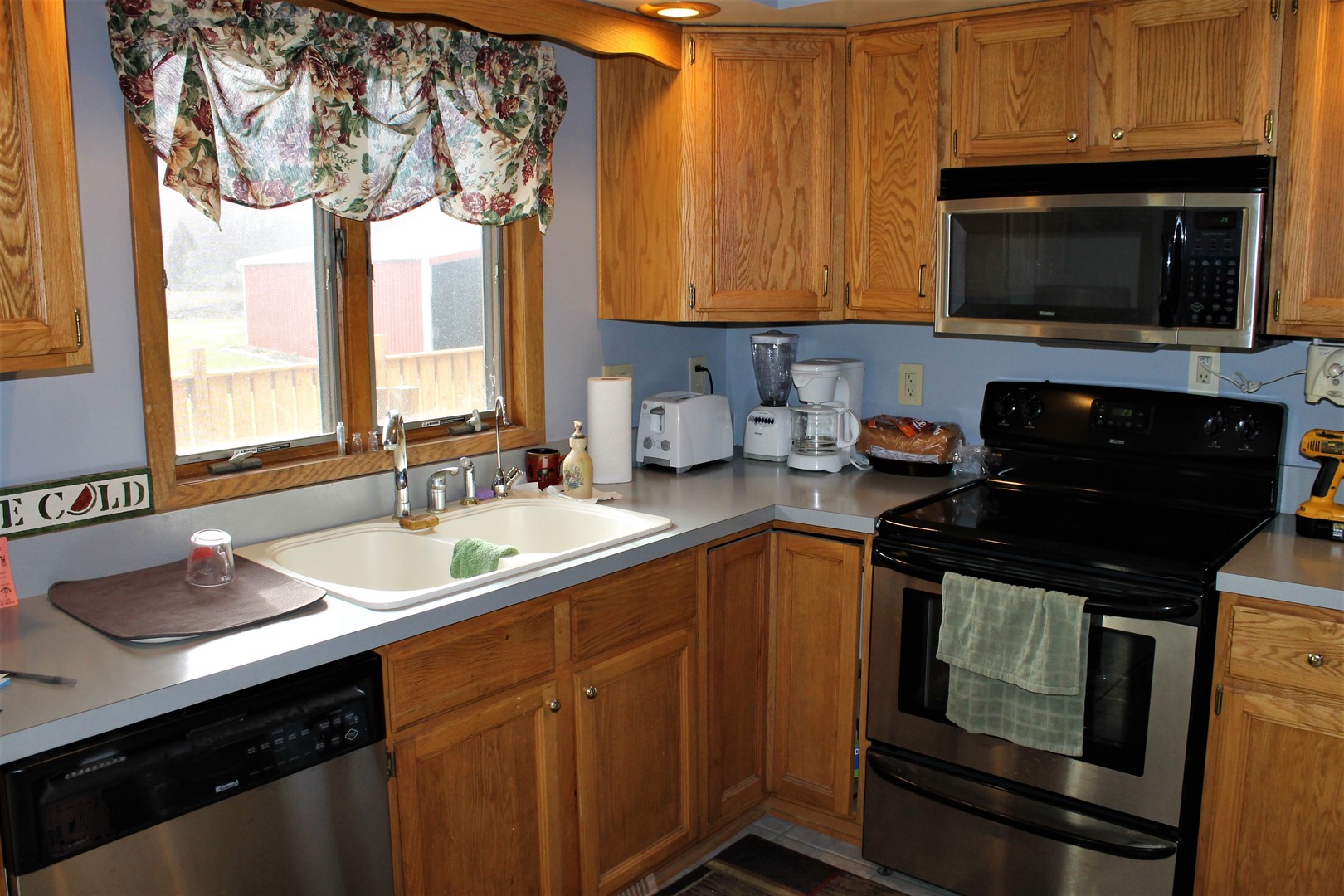 8776 Wolf Road Kingston, IL 60145 - Photo 16 of 35 a kitchen with a sink stove and microwave