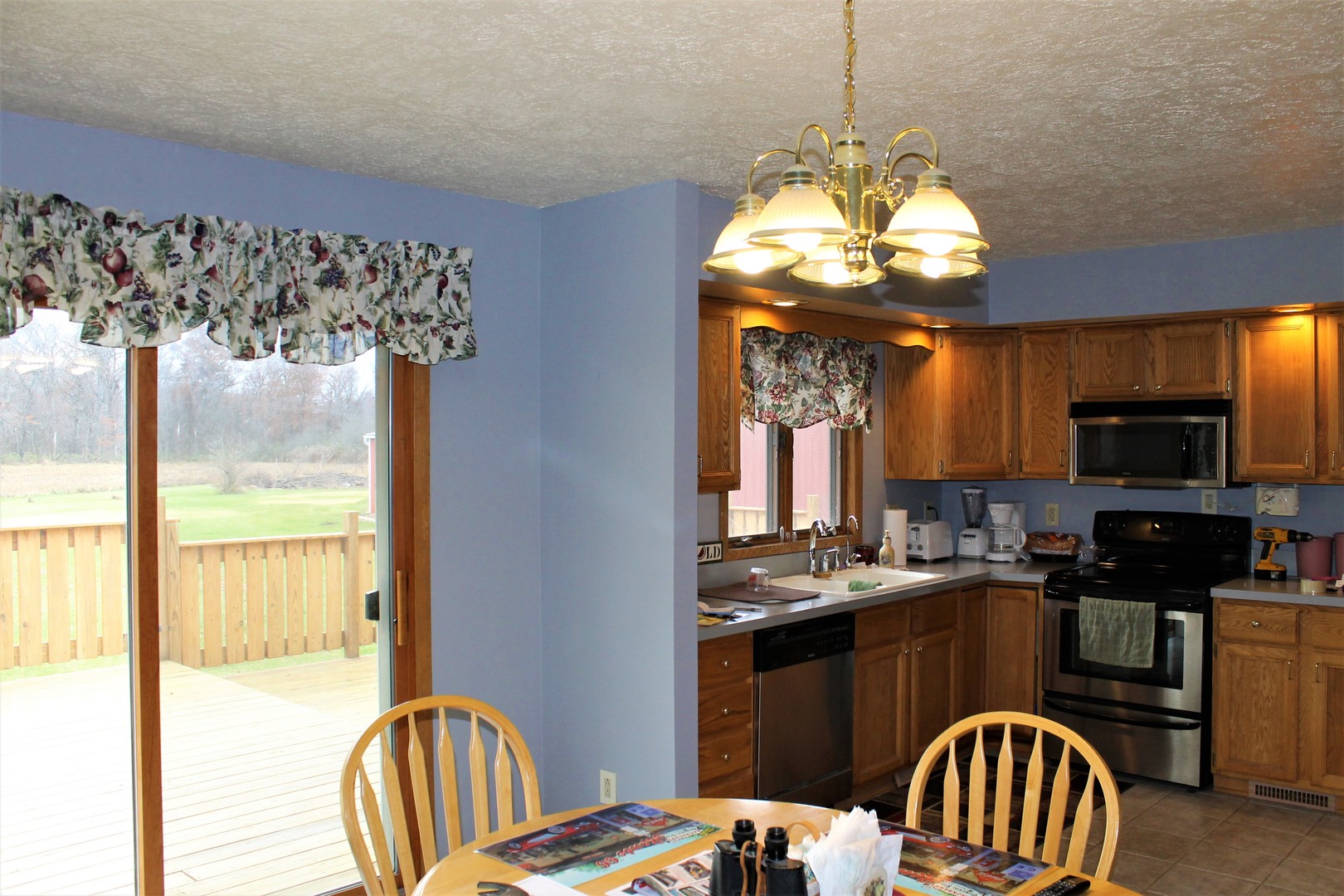 8776 Wolf Road Kingston, IL 60145 - Photo 17 of 35 a kitchen with sink refrigerator dining table and chairs
