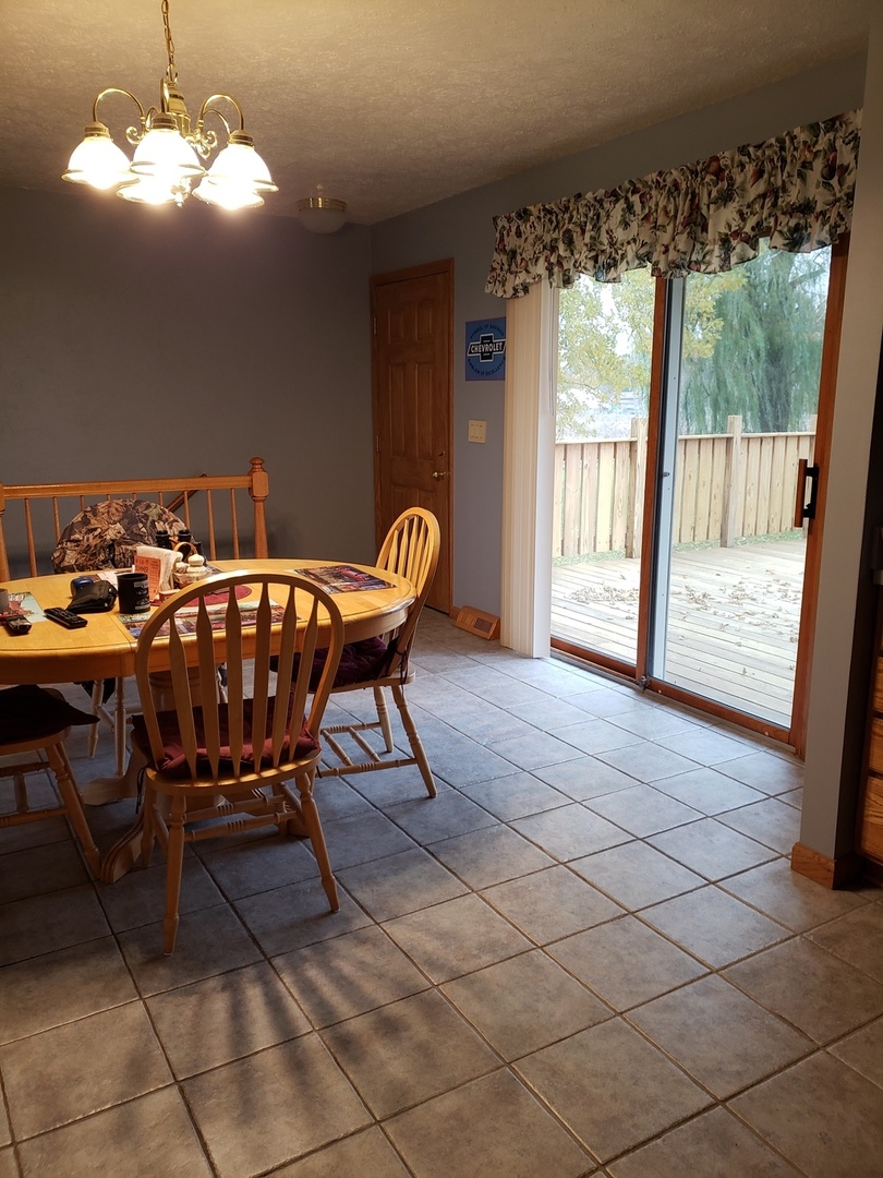 8776 Wolf Road Kingston, IL 60145 - Photo 19 of 35 a view of a dining room with furniture window and outside view