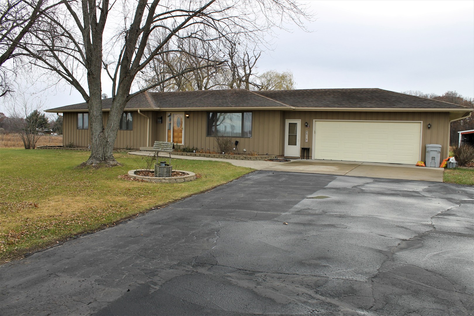 8776 Wolf Road Kingston, IL 60145 - Photo 3 of 35 a front view of a house with a yard and garage