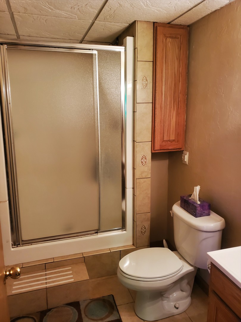8776 Wolf Road Kingston, IL 60145 - Photo 26 of 35 a bathroom with a granite countertop toilet and a sink