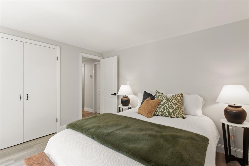 1049 Pleasant Street Canton, MA 02021 - Photo 8 of 16 a bedroom with a bed and a lamp