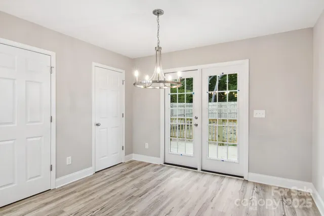 a view of wooden floor and windows in a room