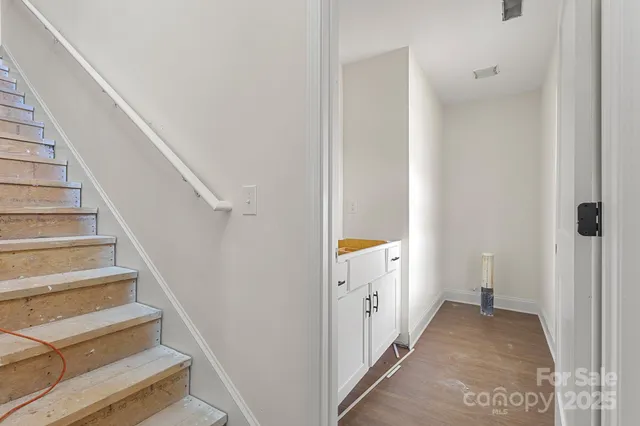 a view of a hallway with wooden floor and entryway