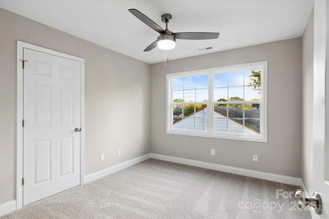 a view of a livingroom with a ceiling fan and window