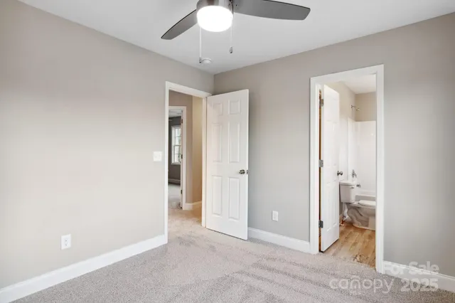 a view of an empty room and bathroom