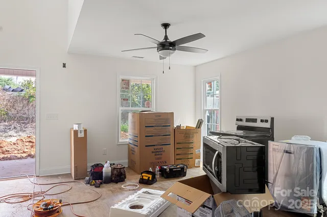 a view of a workspace with furniture and a window