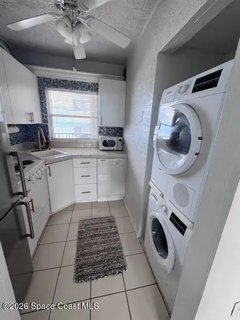 a kitchen with a sink a stove top oven and cabinets