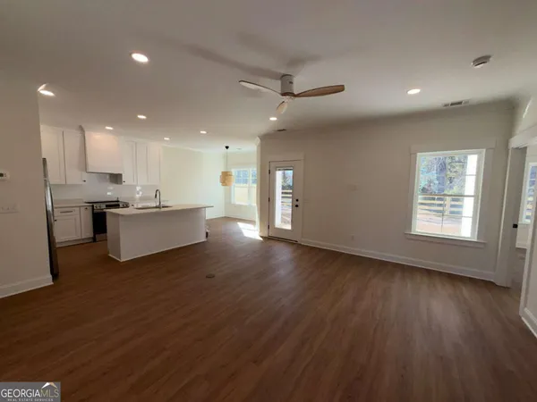 a view of kitchen with wooden floor and electronic appliances