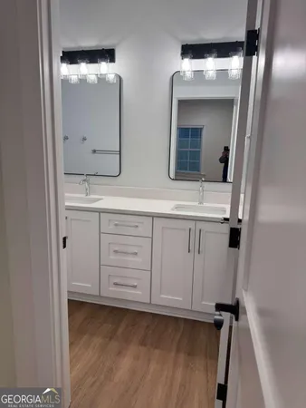 a bathroom with a double vanity sink and mirror