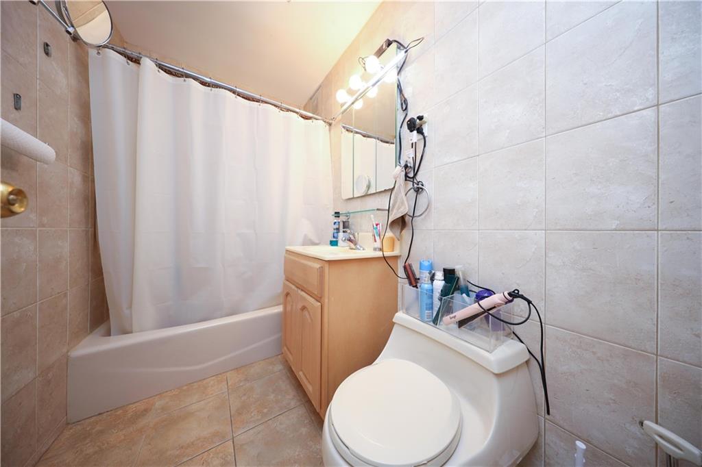 1625 Emmons Avenue, Unit 4N Brooklyn, NY 11235 - Photo 15 of 32 a bathroom with a sink a toilet and tub