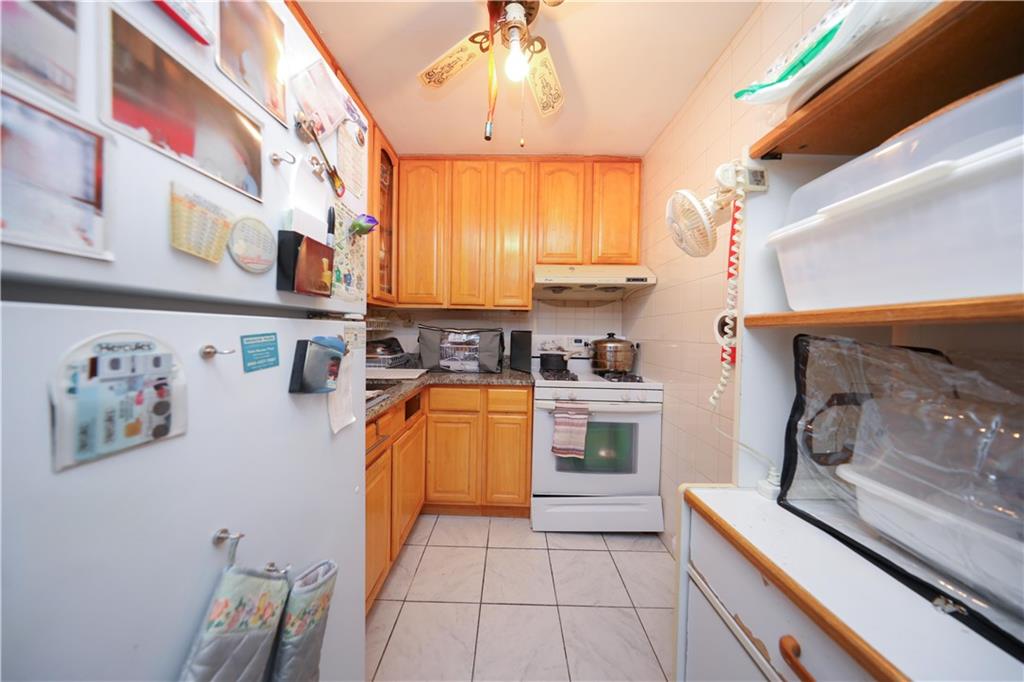 1625 Emmons Avenue, Unit 4N Brooklyn, NY 11235 - Photo 9 of 32 a kitchen with stainless steel appliances granite countertop a stove a sink and a refrigerator