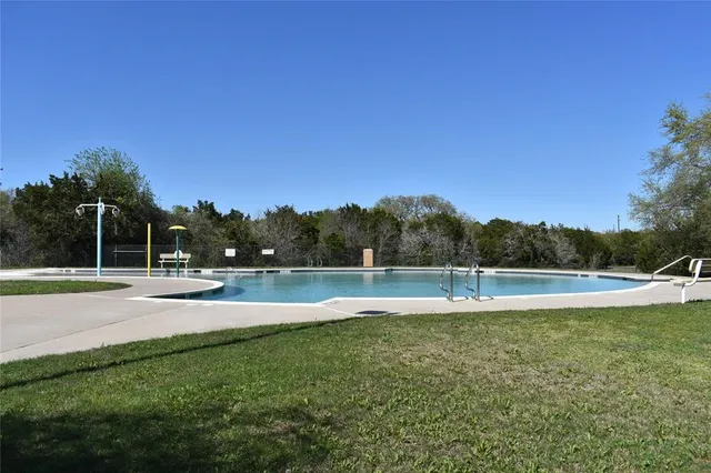 a view of a swimming pool with an outdoor space and seating area