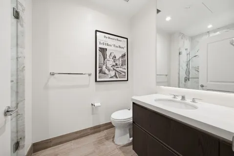 a bedroom with a flat screen tv bed and a potted plant