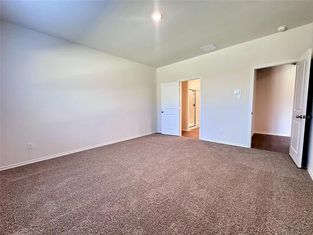 a view of an empty room and a window