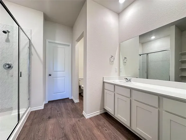 a spacious bathroom with a double vanity sink and a mirror