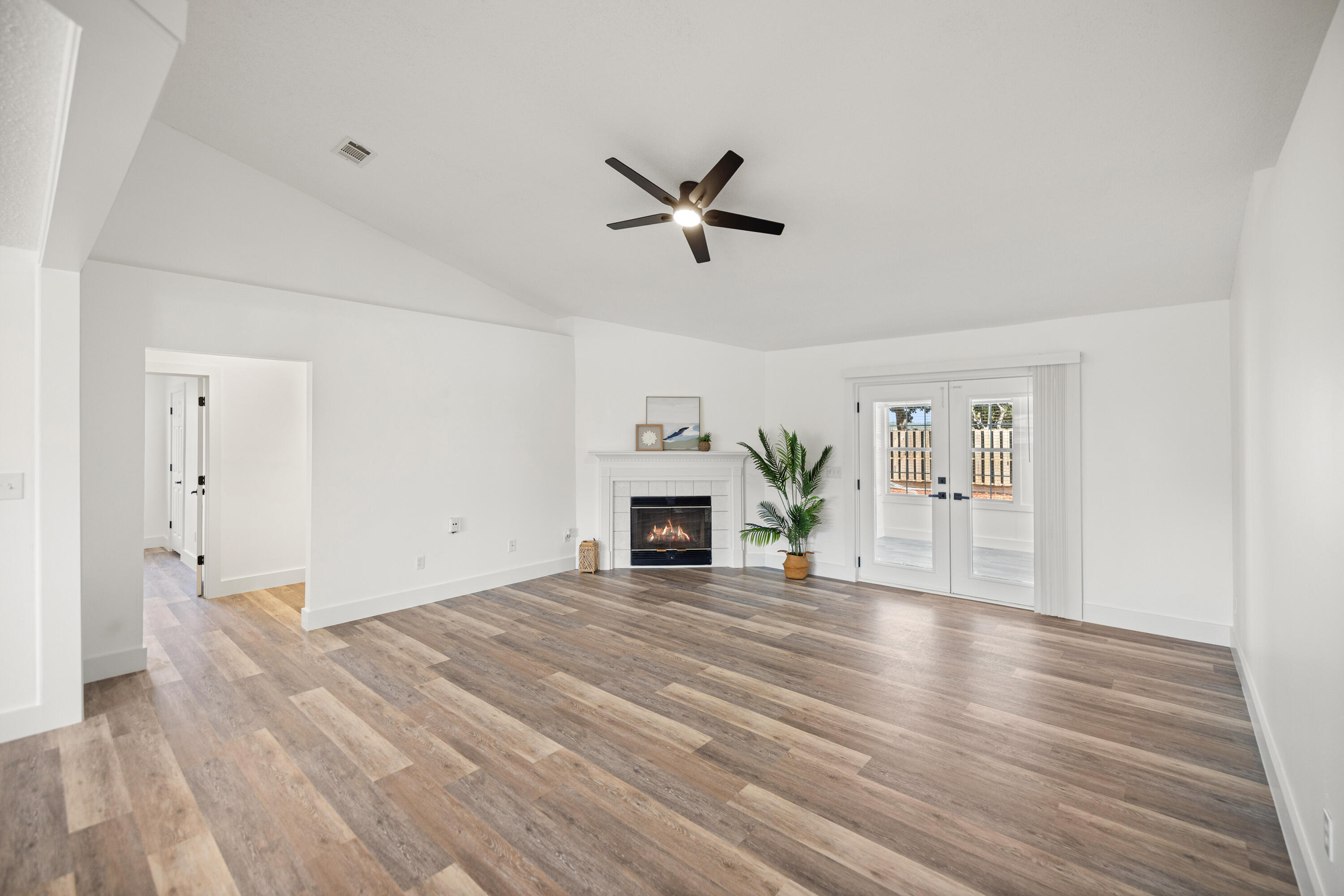 2001 Jessica Way Navarre, FL 32566 - Photo 12 of 73 a view of a livingroom with fireplace a ceiling fan and wooden floor