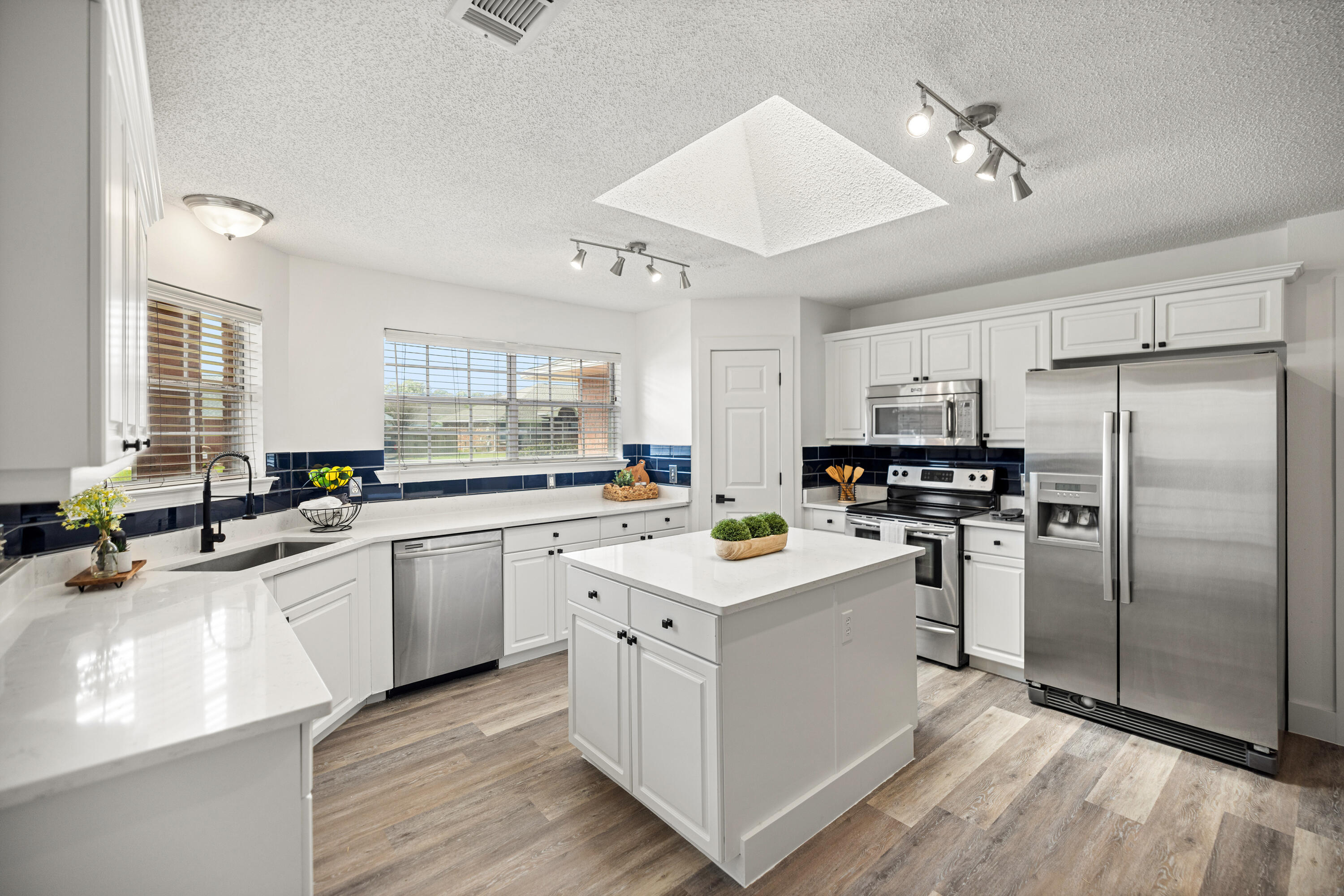 2001 Jessica Way Navarre, FL 32566 - Photo 16 of 73 a kitchen with a sink stainless steel appliances cabinets and a window