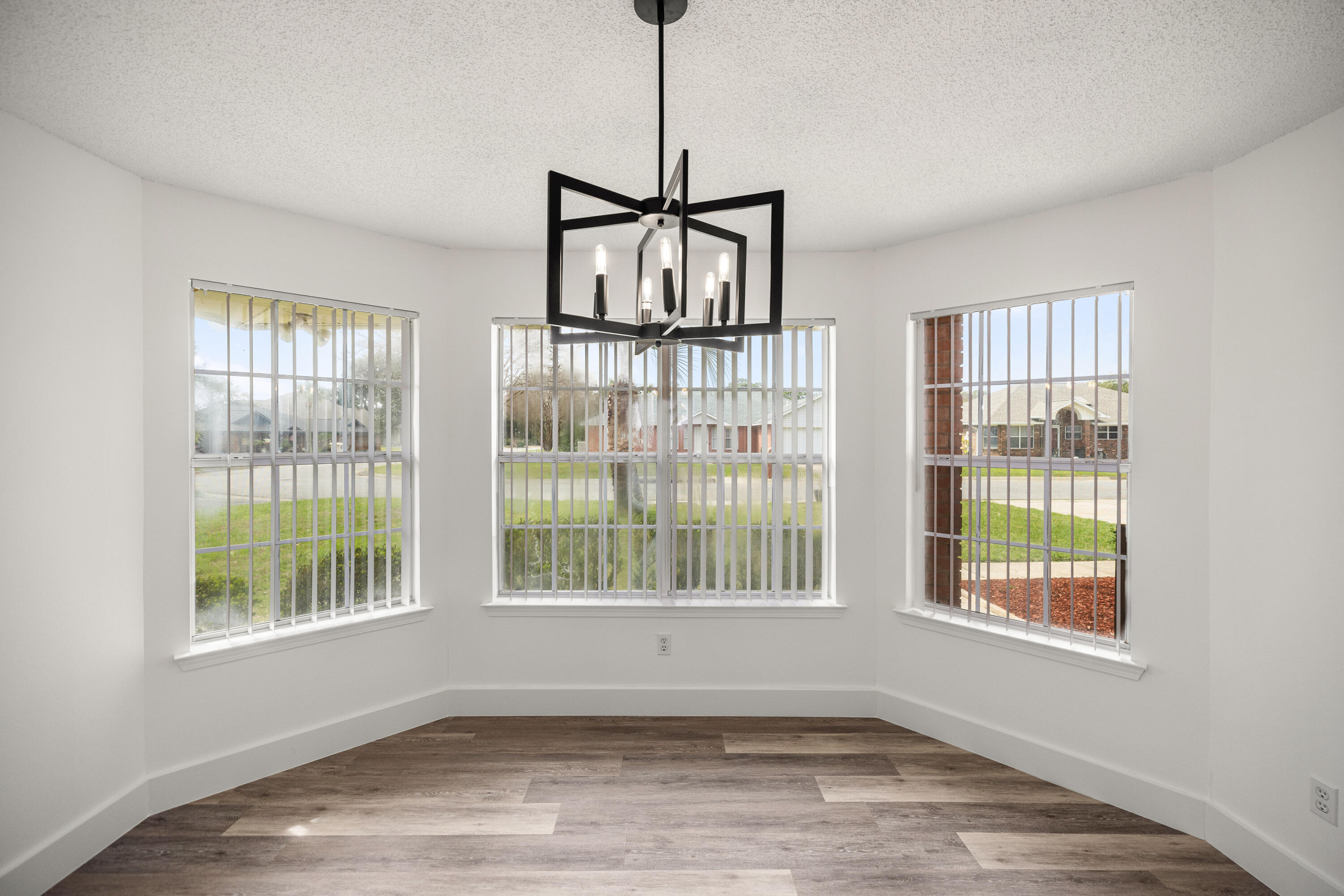 2001 Jessica Way Navarre, FL 32566 - Photo 24 of 73 a view of an empty room with wooden floor and a window