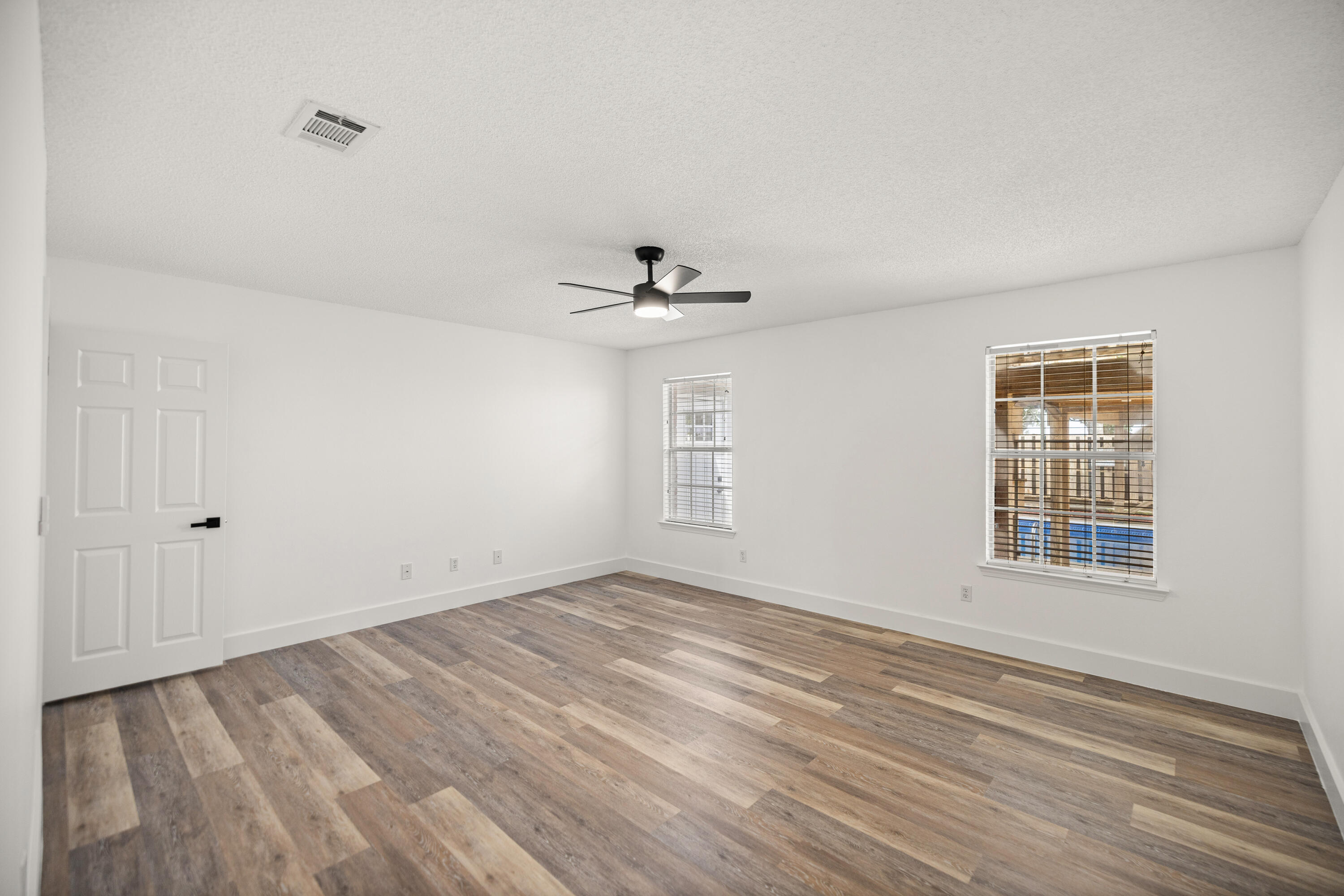 2001 Jessica Way Navarre, FL 32566 - Photo 28 of 73 a view of empty room with wooden floor and fan