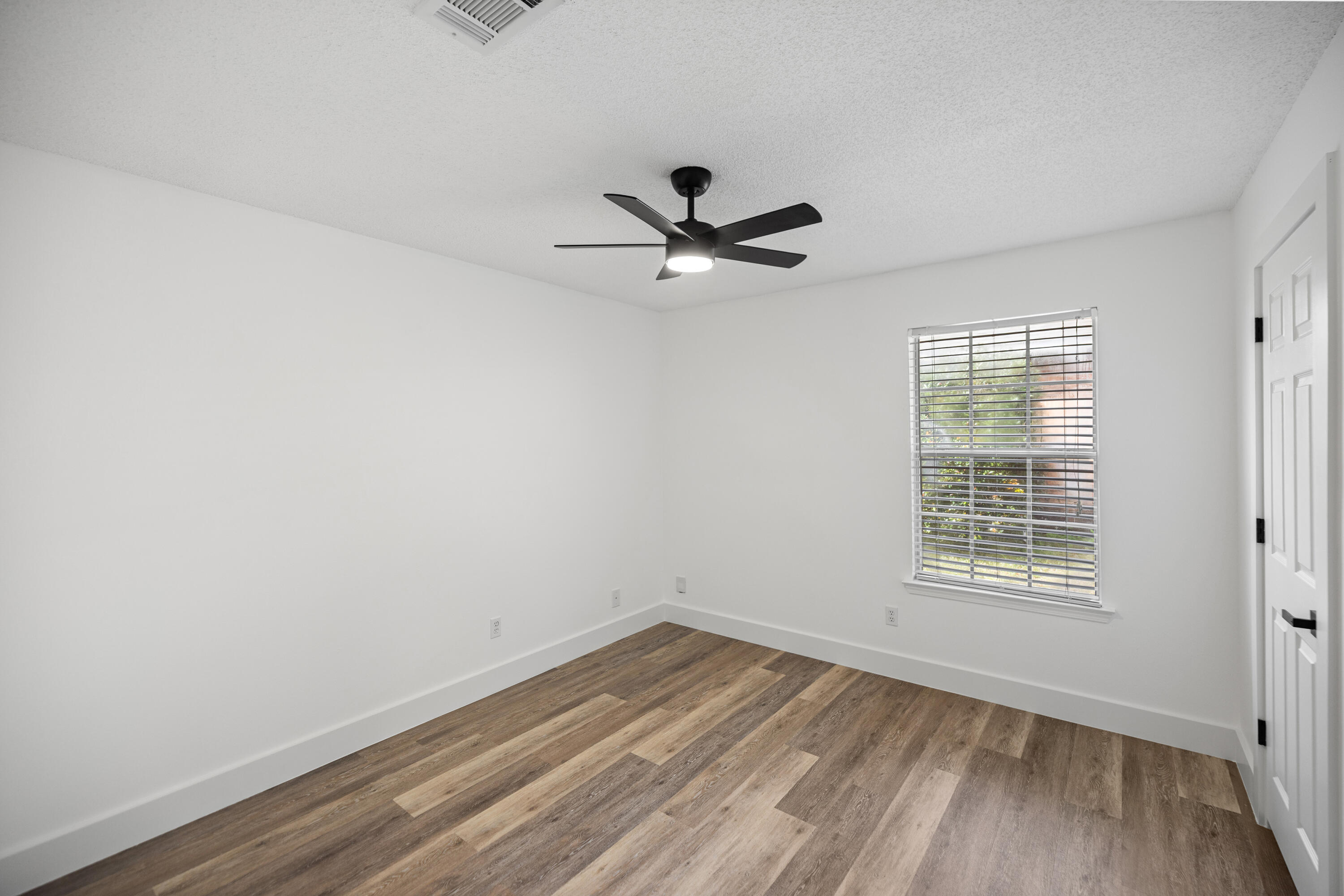 2001 Jessica Way Navarre, FL 32566 - Photo 41 of 73 an empty room with a window and a ceiling fan