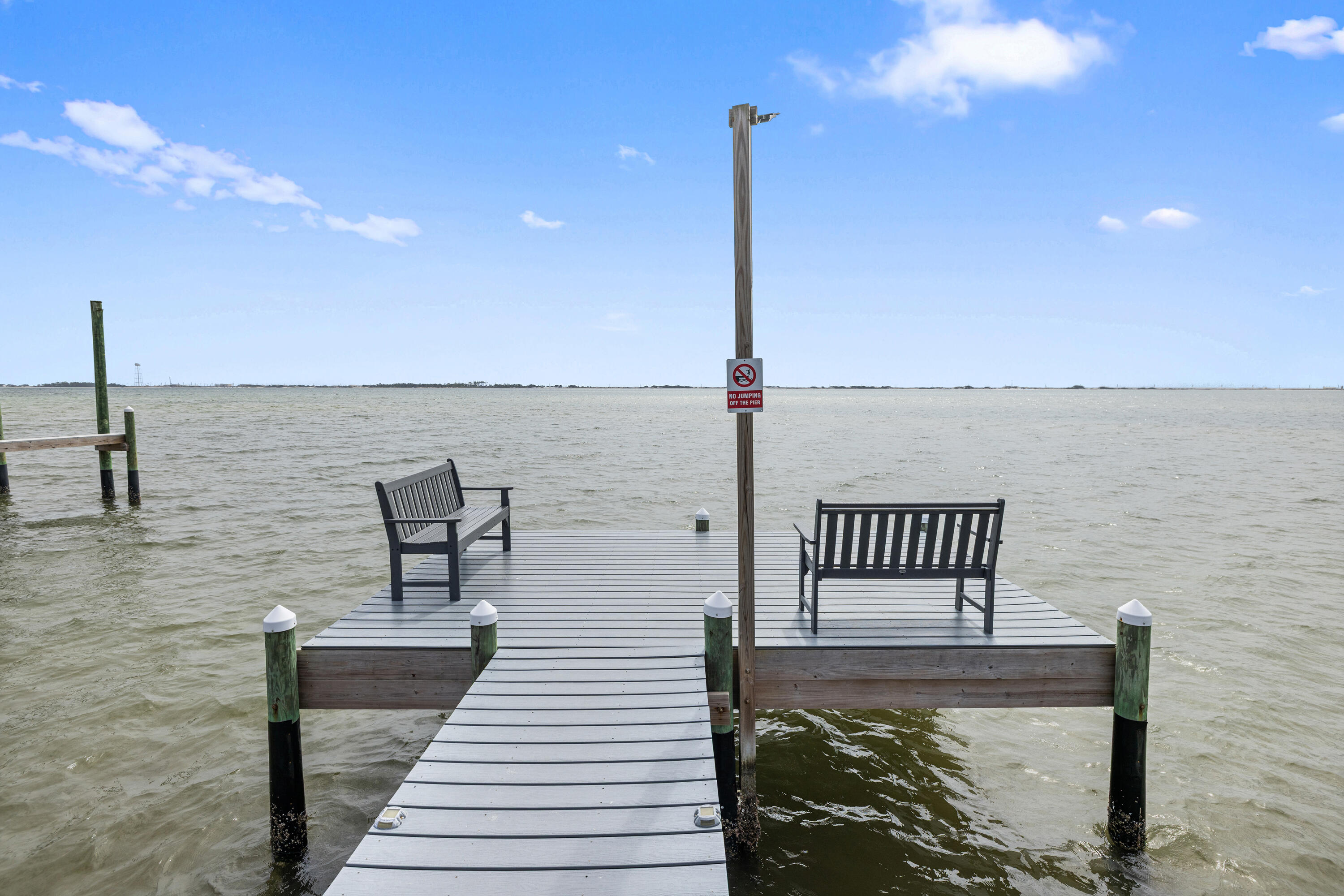 2001 Jessica Way Navarre, FL 32566 - Photo 70 of 73 a view of a balcony with two chairs and wooden floor