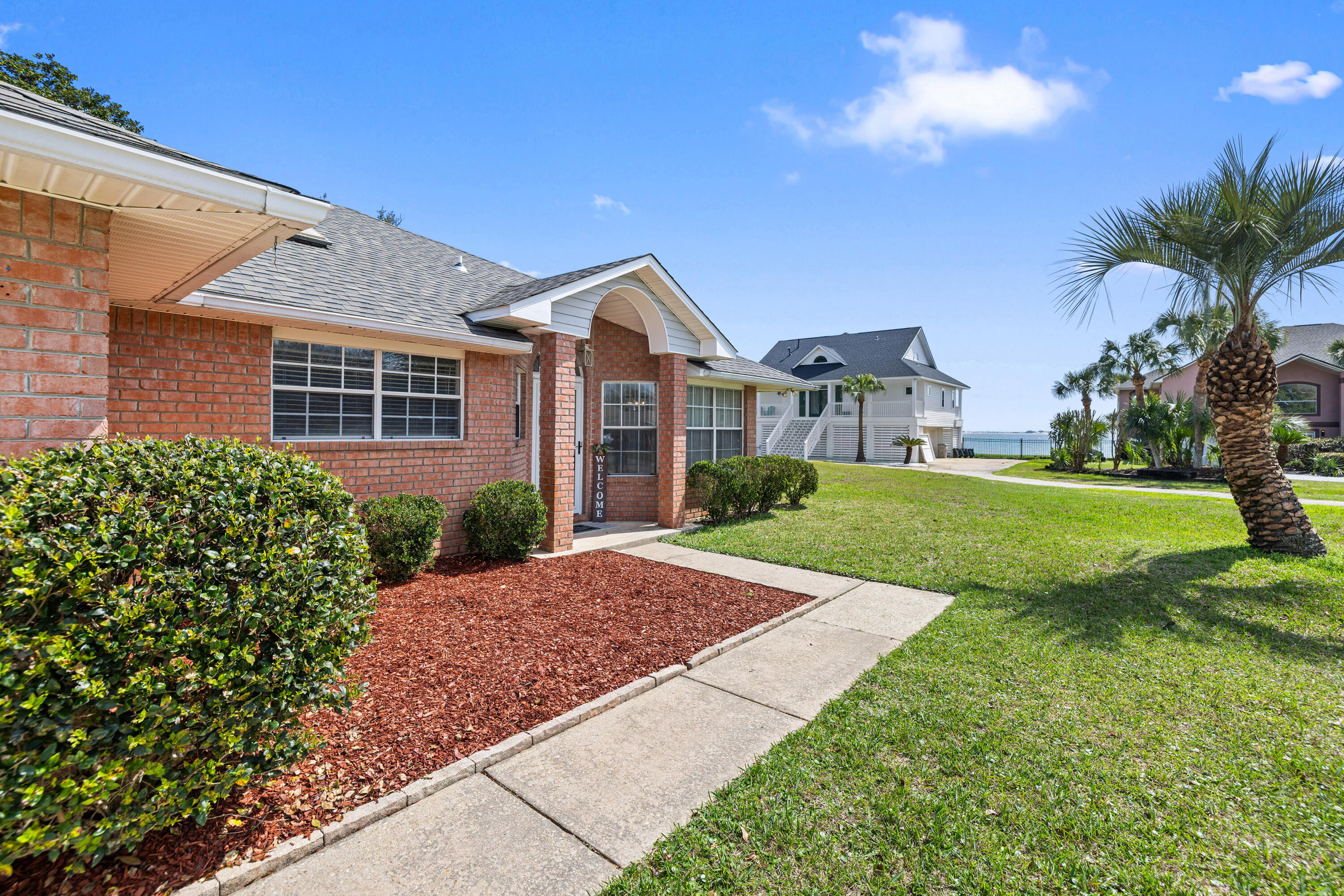 2001 Jessica Way Navarre, FL 32566 - Photo 7 of 73 a view of house in front of a big yard with potted plants