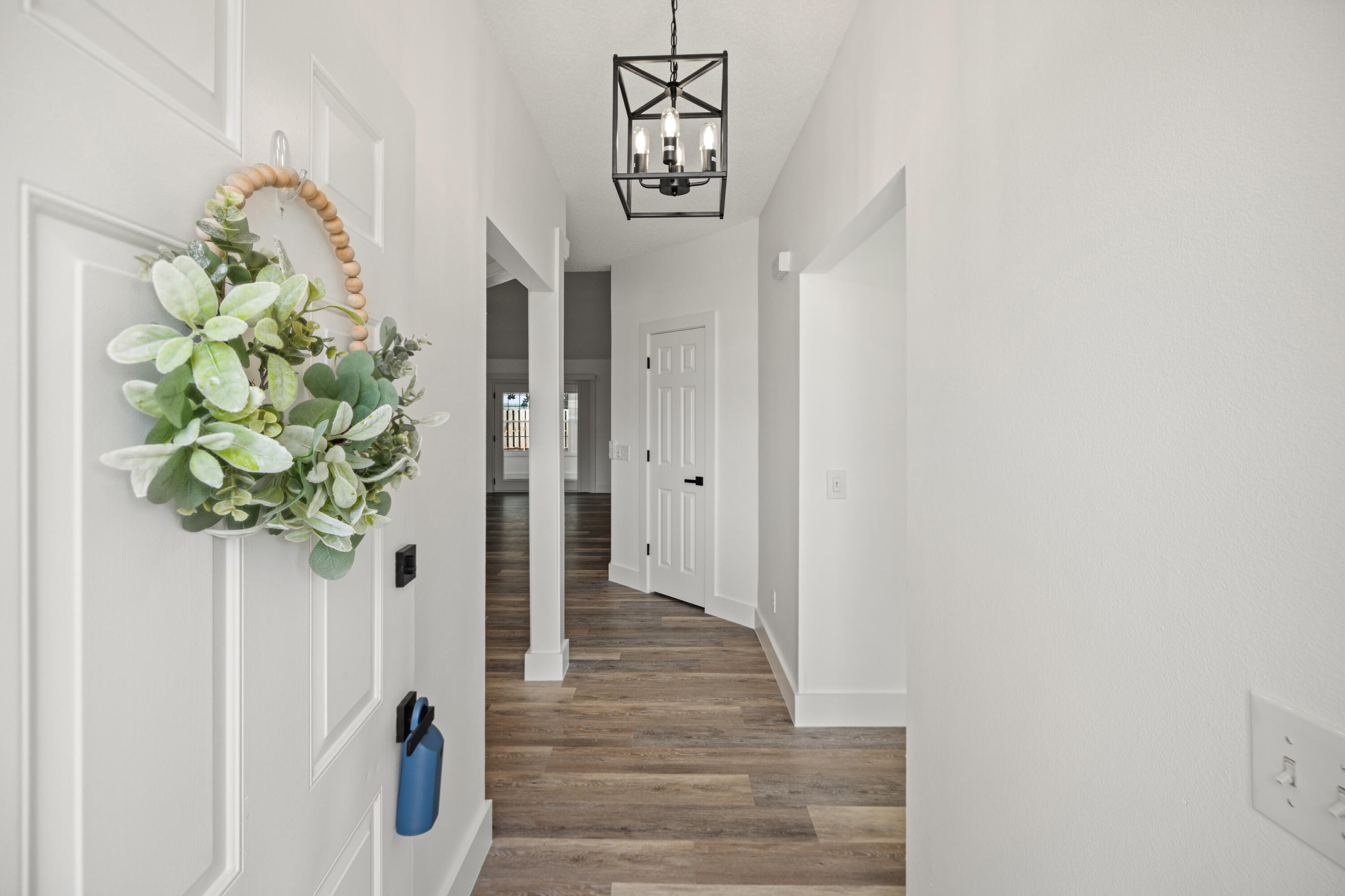 2001 Jessica Way Navarre, FL 32566 - Photo 10 of 73 a view of a hallway with wooden floor