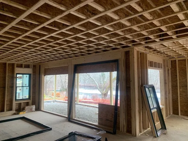 a view of a room with wooden floor and windows
