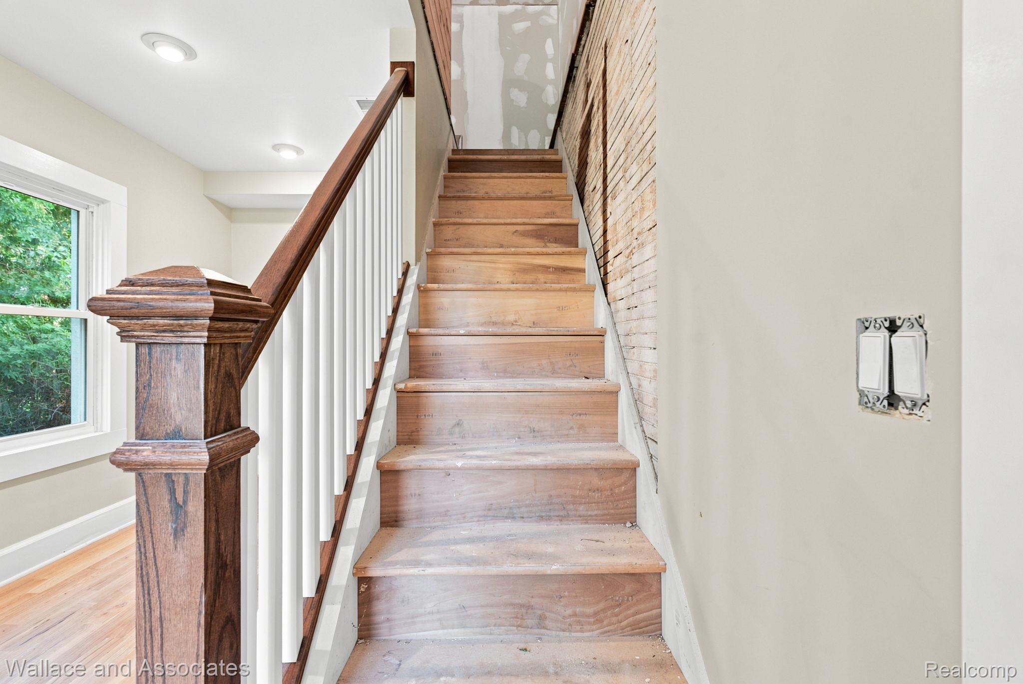 5949 Roach Road Croswell, MI 48422 - Photo 34 of 48 Staircase featuring wood treads and a wood-finish newel post with white spindles