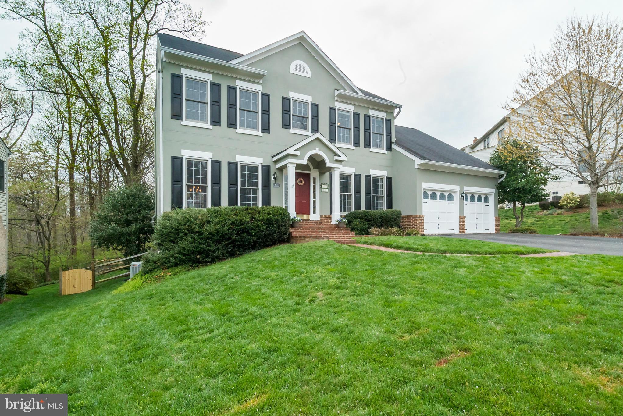 8759 Center Road Springfield, VA 22152 - Photo 1 of 30 a front view of a house with a yard and trees