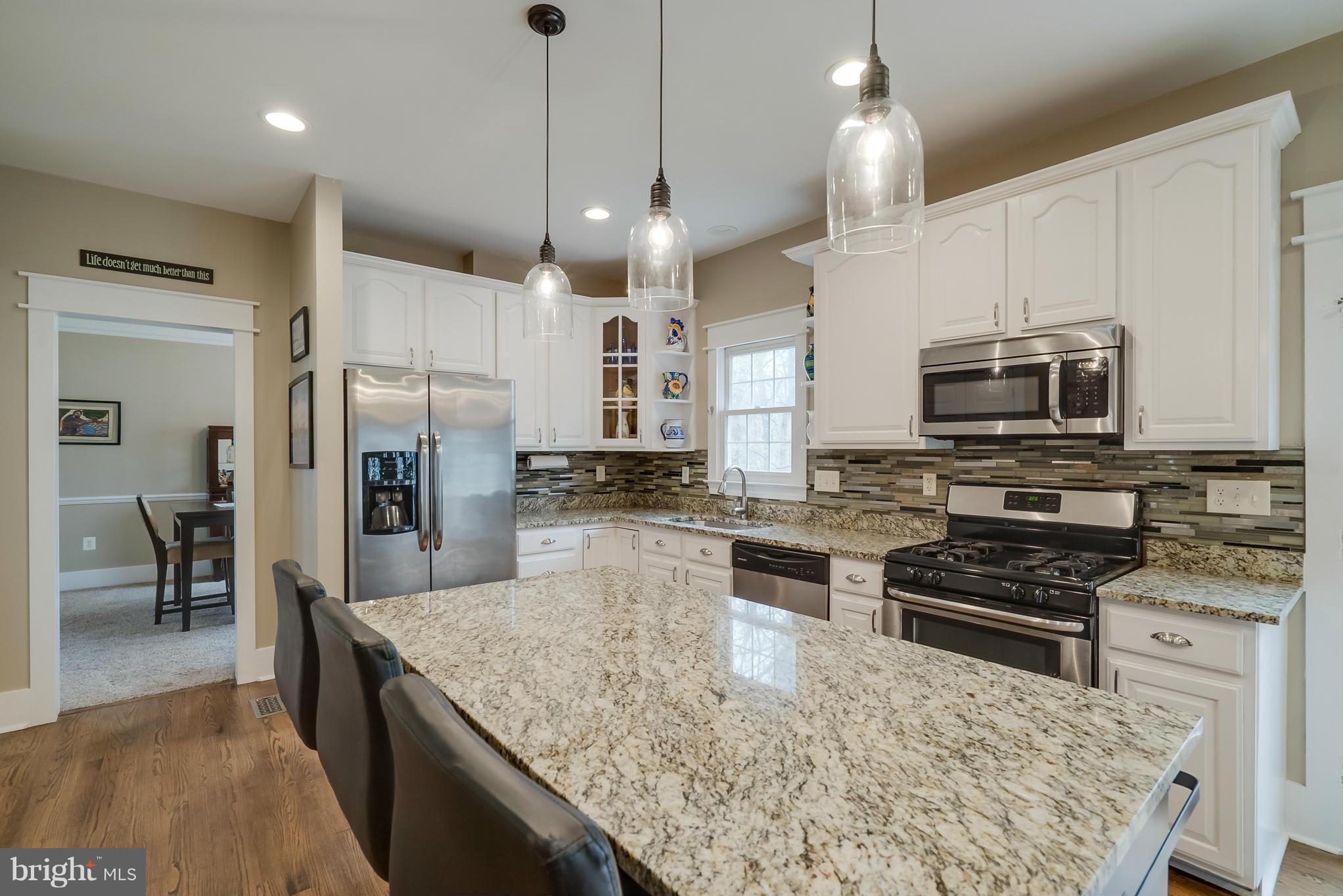 8759 Center Road Springfield, VA 22152 - Photo 2 of 30 a kitchen with stainless steel appliances granite countertop a stove refrigerator and microwave