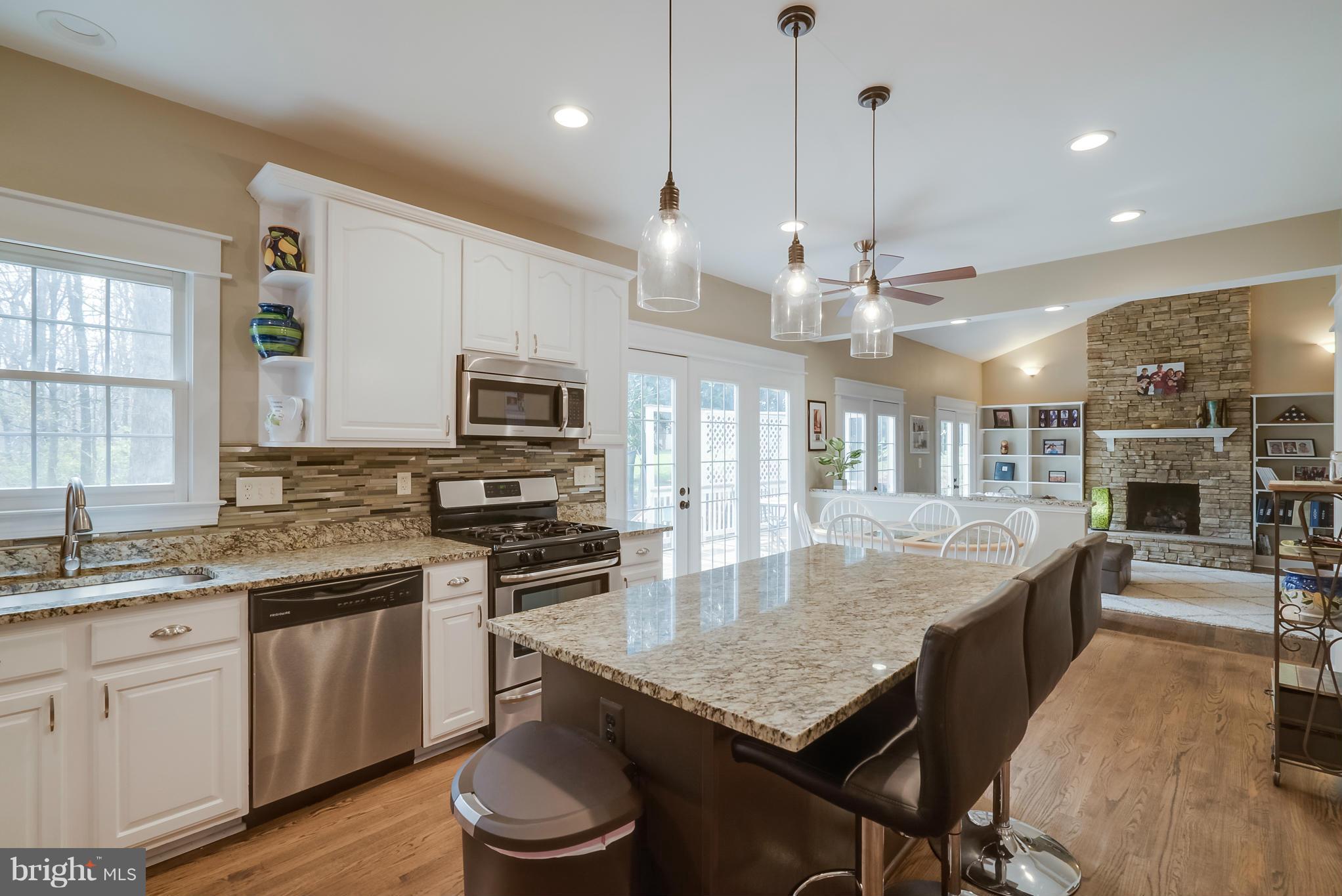 8759 Center Road Springfield, VA 22152 - Photo 3 of 30 a kitchen with stainless steel appliances granite countertop a stove refrigerator and microwave