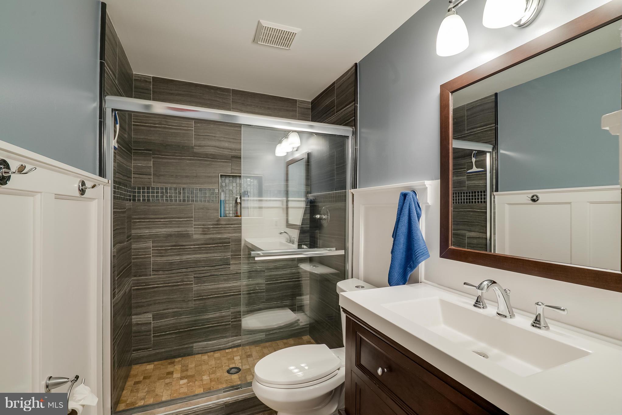 8759 Center Road Springfield, VA 22152 - Photo 25 of 30 a bathroom with a sink toilet and shower