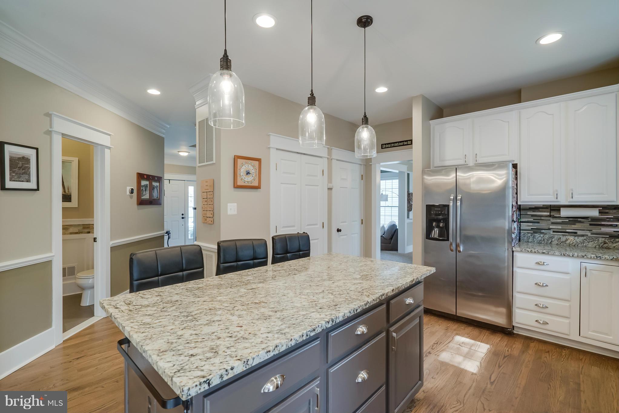 8759 Center Road Springfield, VA 22152 - Photo 4 of 30 a kitchen with stainless steel appliances granite countertop wooden cabinets a refrigerator and a sink
