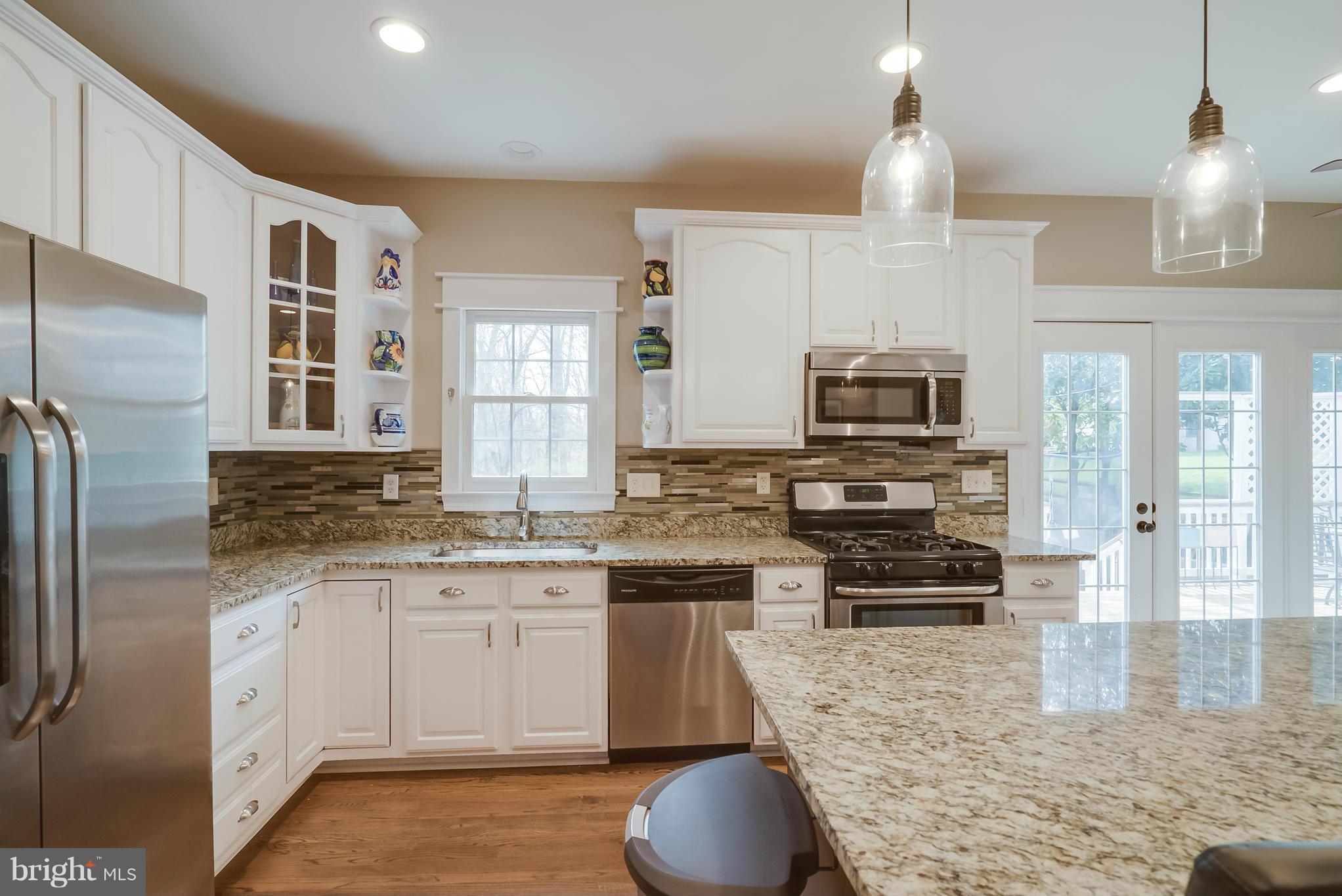 8759 Center Road Springfield, VA 22152 - Photo 6 of 30 a kitchen with stainless steel appliances granite countertop a sink a stove a refrigerator cabinets and living room view