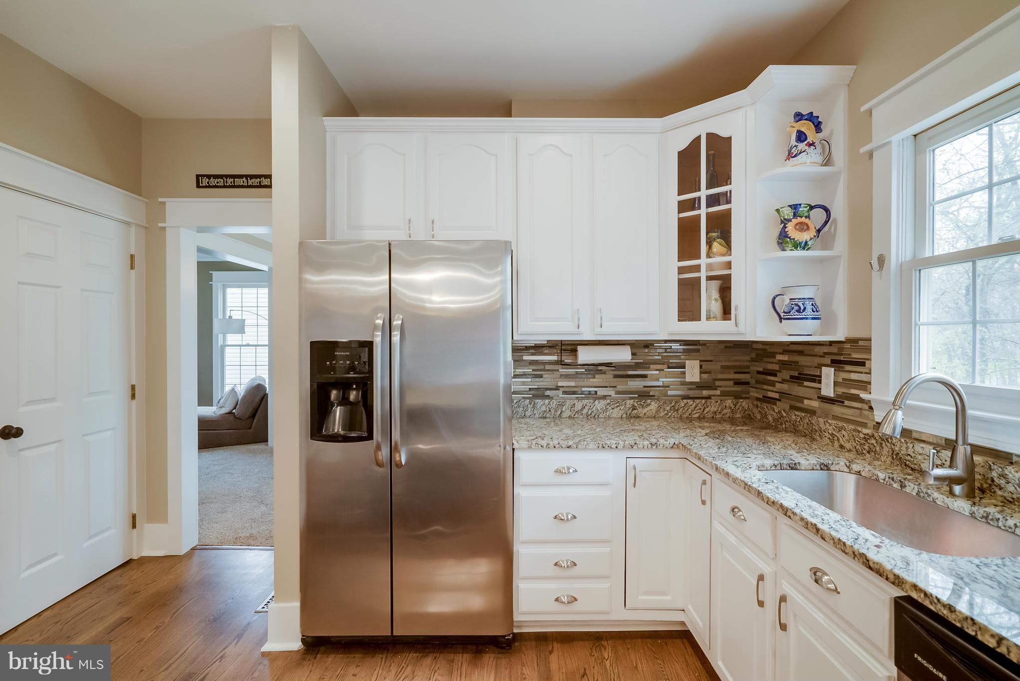 8759 Center Road Springfield, VA 22152 - Photo 7 of 30 a kitchen with granite countertop a refrigerator and a sink