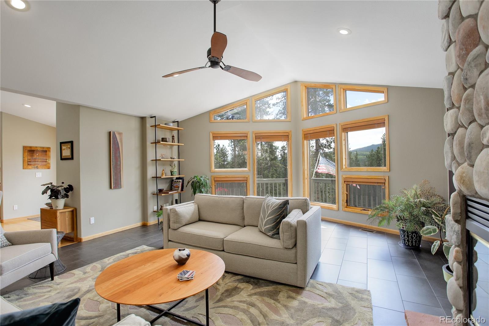 8360 South Warhawk Road Conifer, CO 80433 - Photo 11 of 40 a living room with furniture a table and a large window
