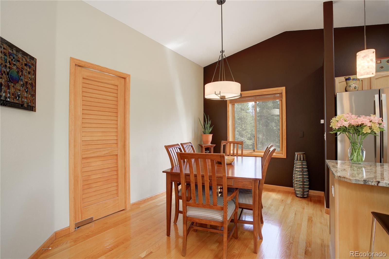 8360 South Warhawk Road Conifer, CO 80433 - Photo 15 of 40 a view of a dining room with furniture window and wooden floor