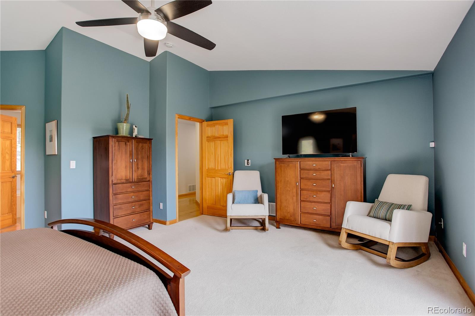 8360 South Warhawk Road Conifer, CO 80433 - Photo 18 of 40 a bedroom with a bed and furniture