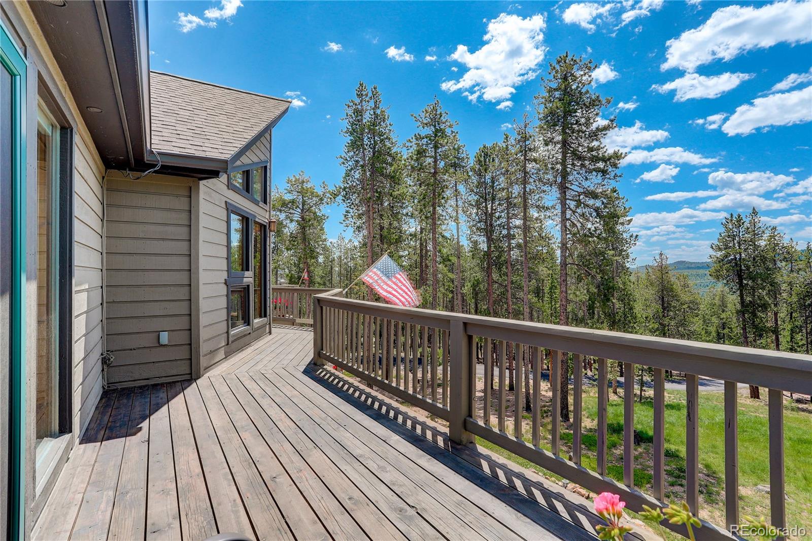 8360 South Warhawk Road Conifer, CO 80433 - Photo 21 of 40 a view of a balcony with wooden floor and bench