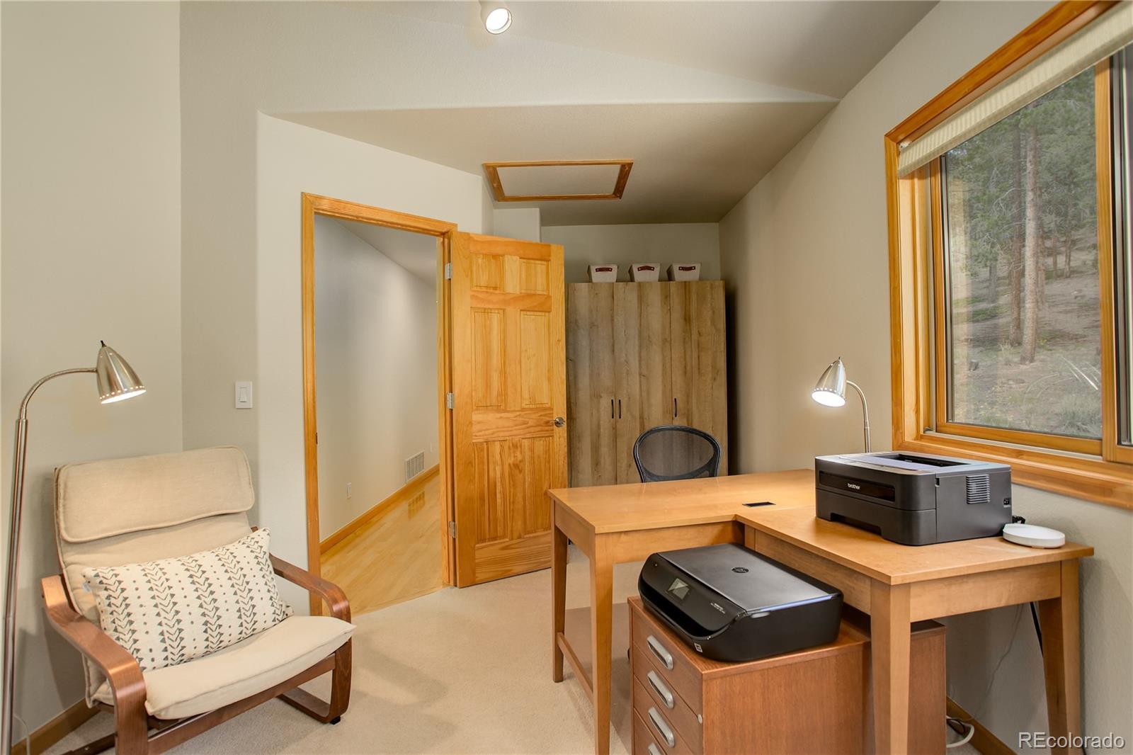 8360 South Warhawk Road Conifer, CO 80433 - Photo 23 of 40 a bedroom with a bed and a window